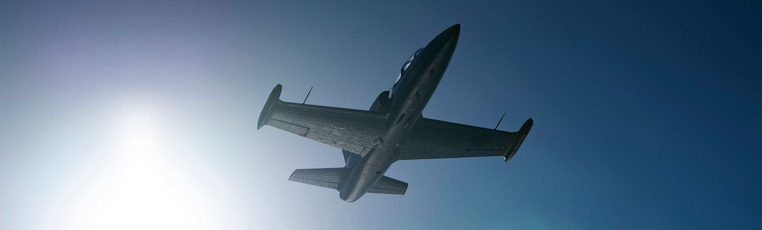 An L-39 Albatros jet against the blue sky with NovAtel’s products inside.